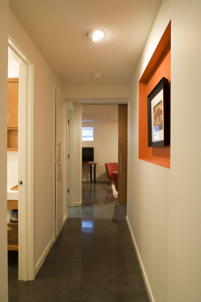Hallway in finished basement after an underpin of the foundation to create a finished basement.
